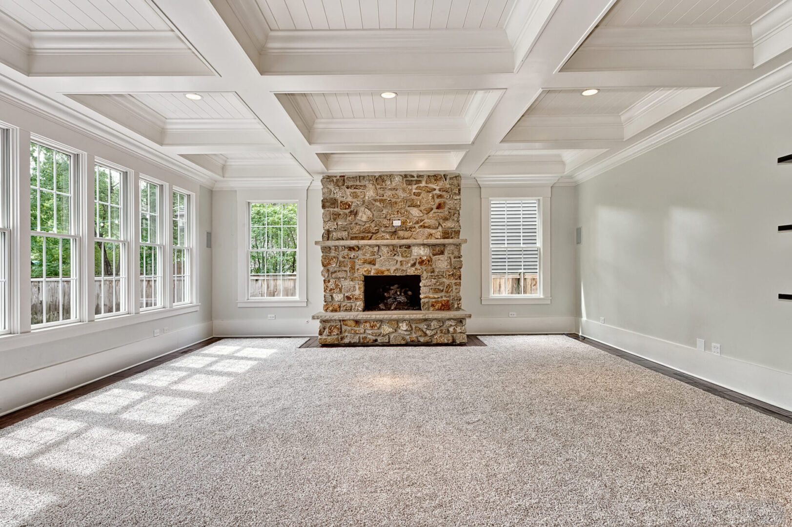 A living room with a fireplace and white walls.